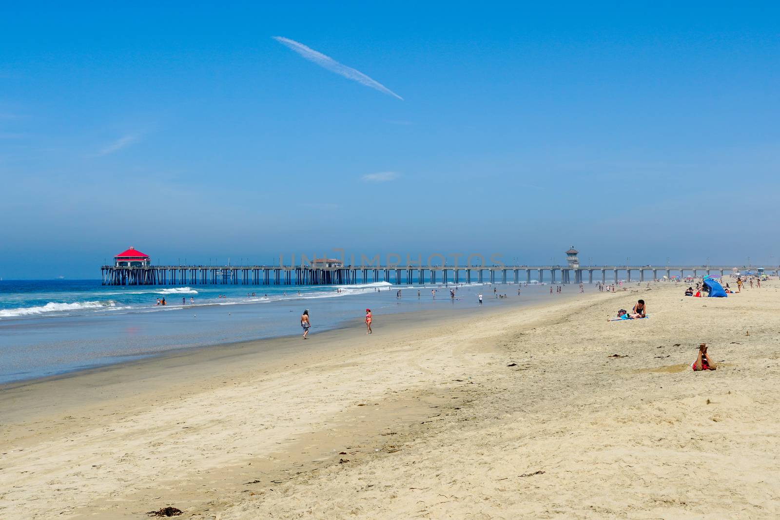 Aerial view of Huntington Pier, beach and coastline during sunny summer day by Bonandbon