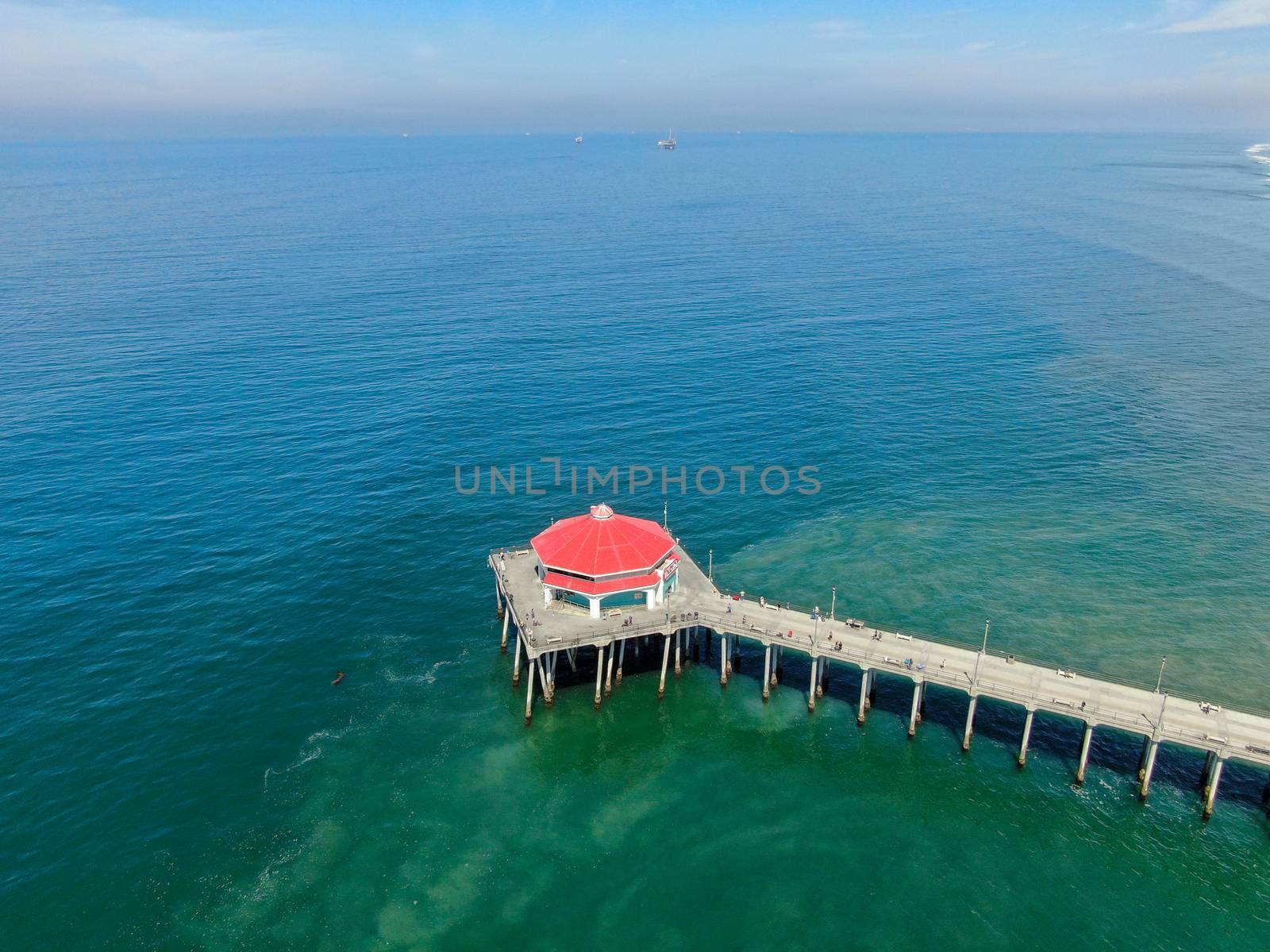 Aerial view of Huntington Pier, beach and coastline during sunny summer day, Southeast of Los Angeles. California. destination for surfer and tourist.