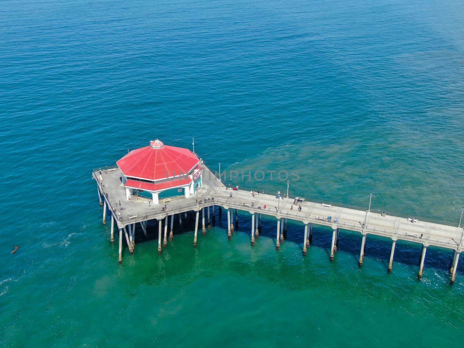 Aerial view of Huntington Pier, beach and coastline during sunny summer day, Southeast of Los Angeles. California. destination for surfer and tourist.