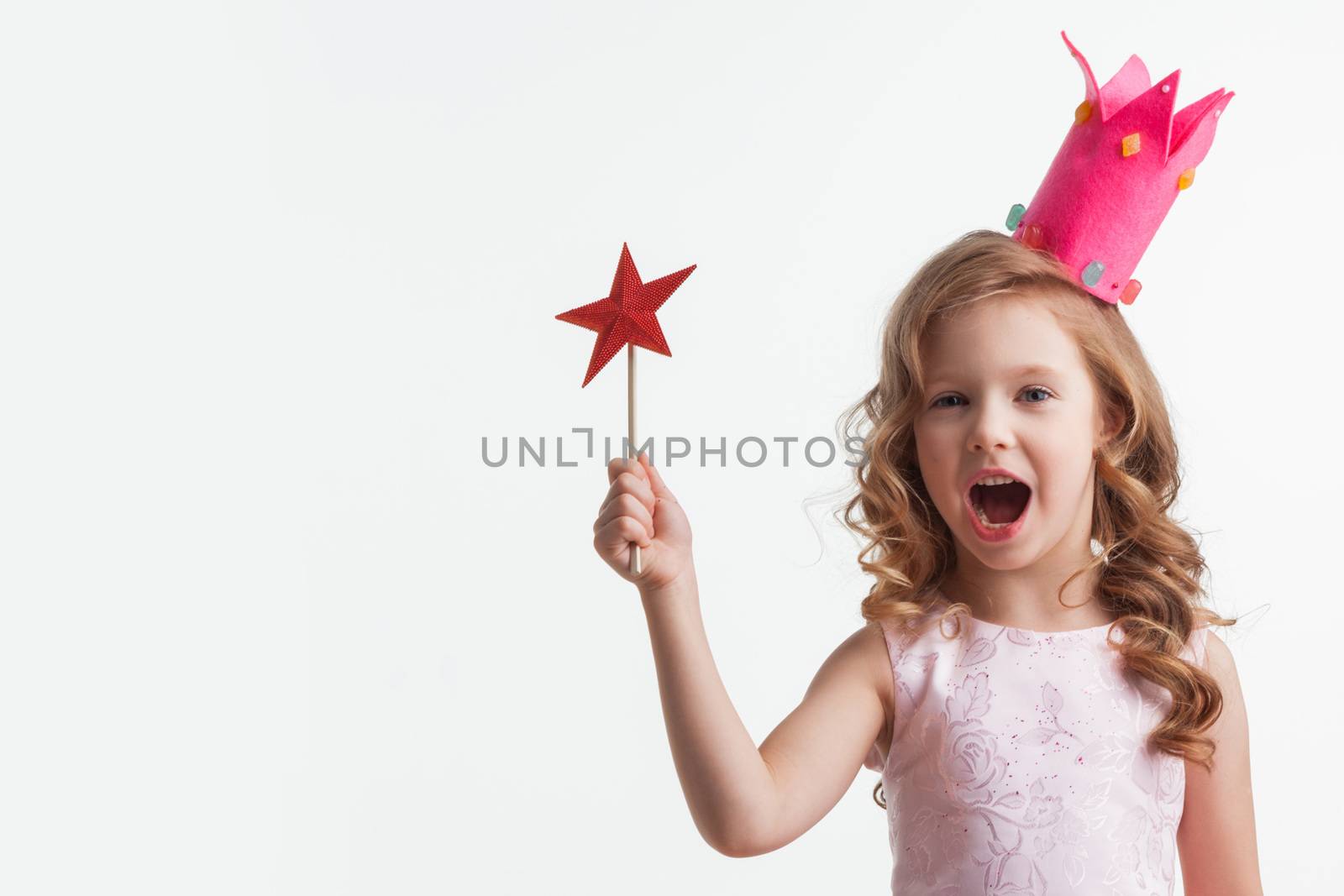 Beautiful little candy princess girl in crown holding star shaped magic wand isolated on white