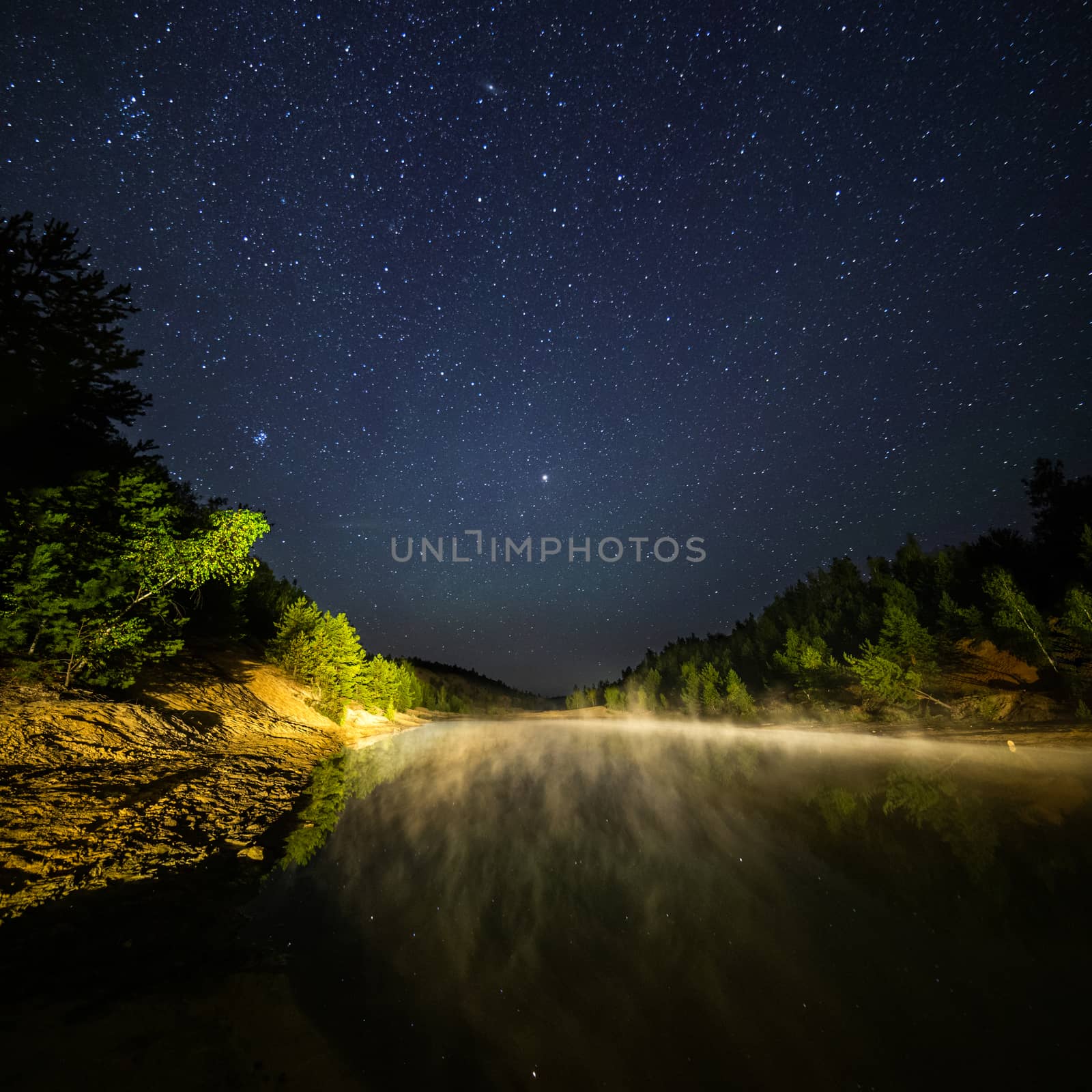small lake under stars at night with foggy vapour at summer by z1b