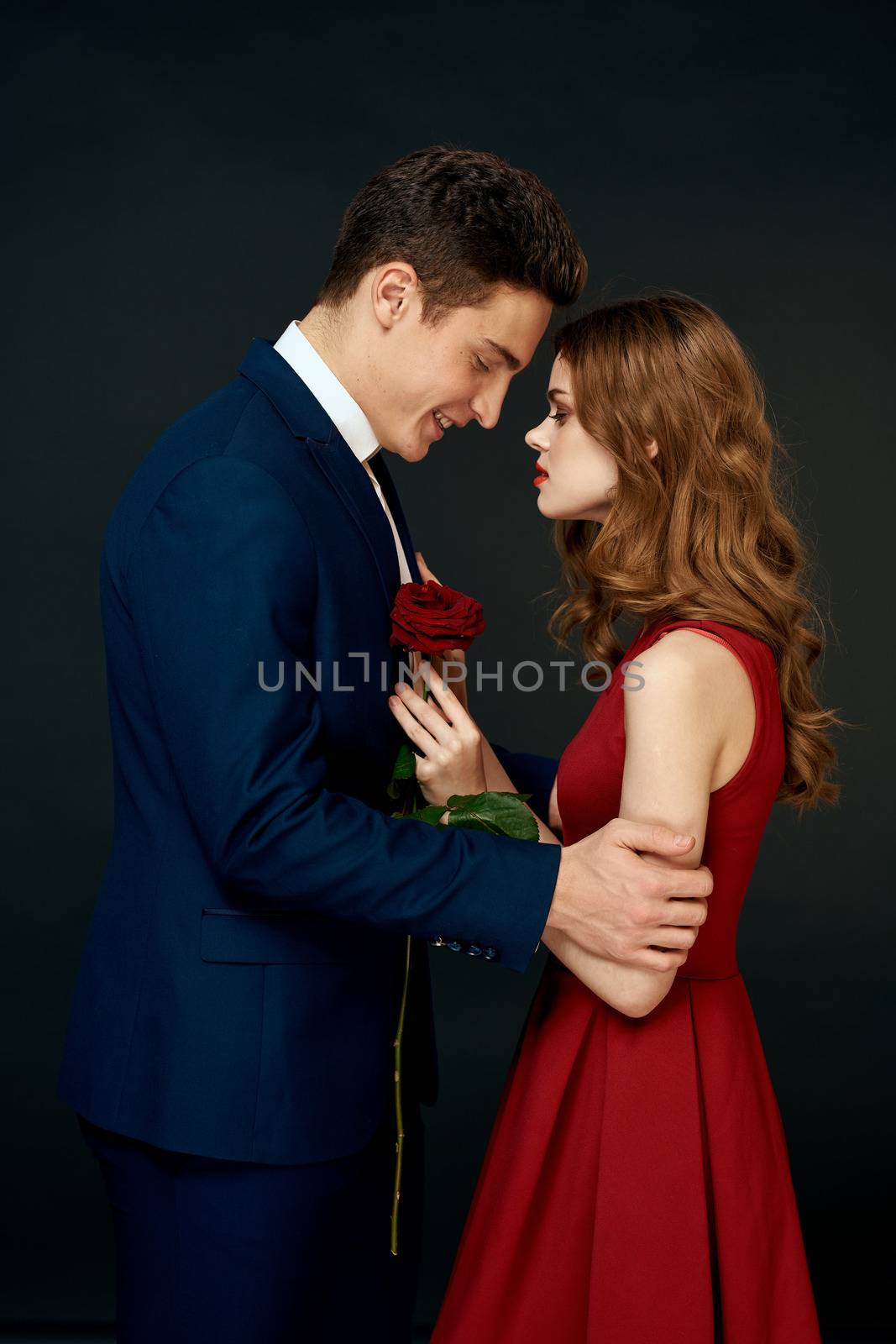 luxury couple hug romance relationship rose over dark isolated background by SHOTPRIME