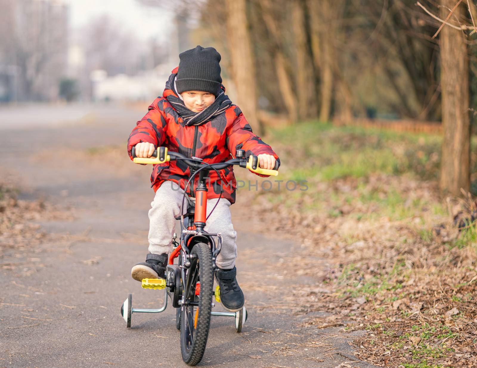 Child boy riding bicycle in the park by Robertobinetti70