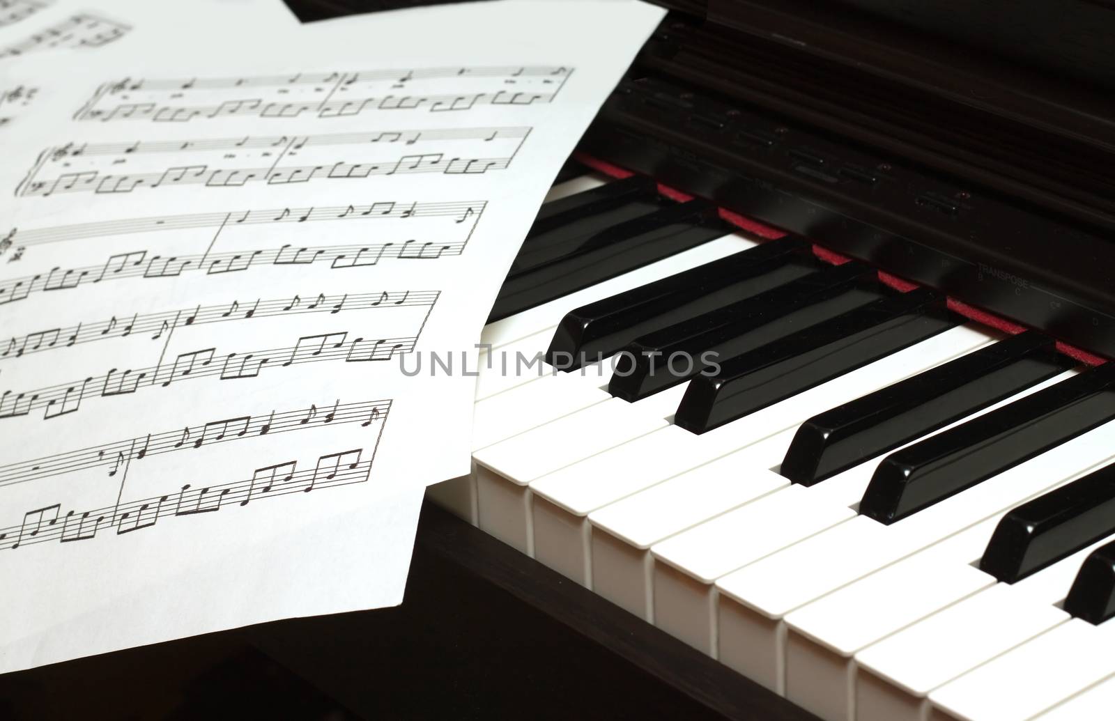 Piano keyboard and music sheets by dymaxfoto