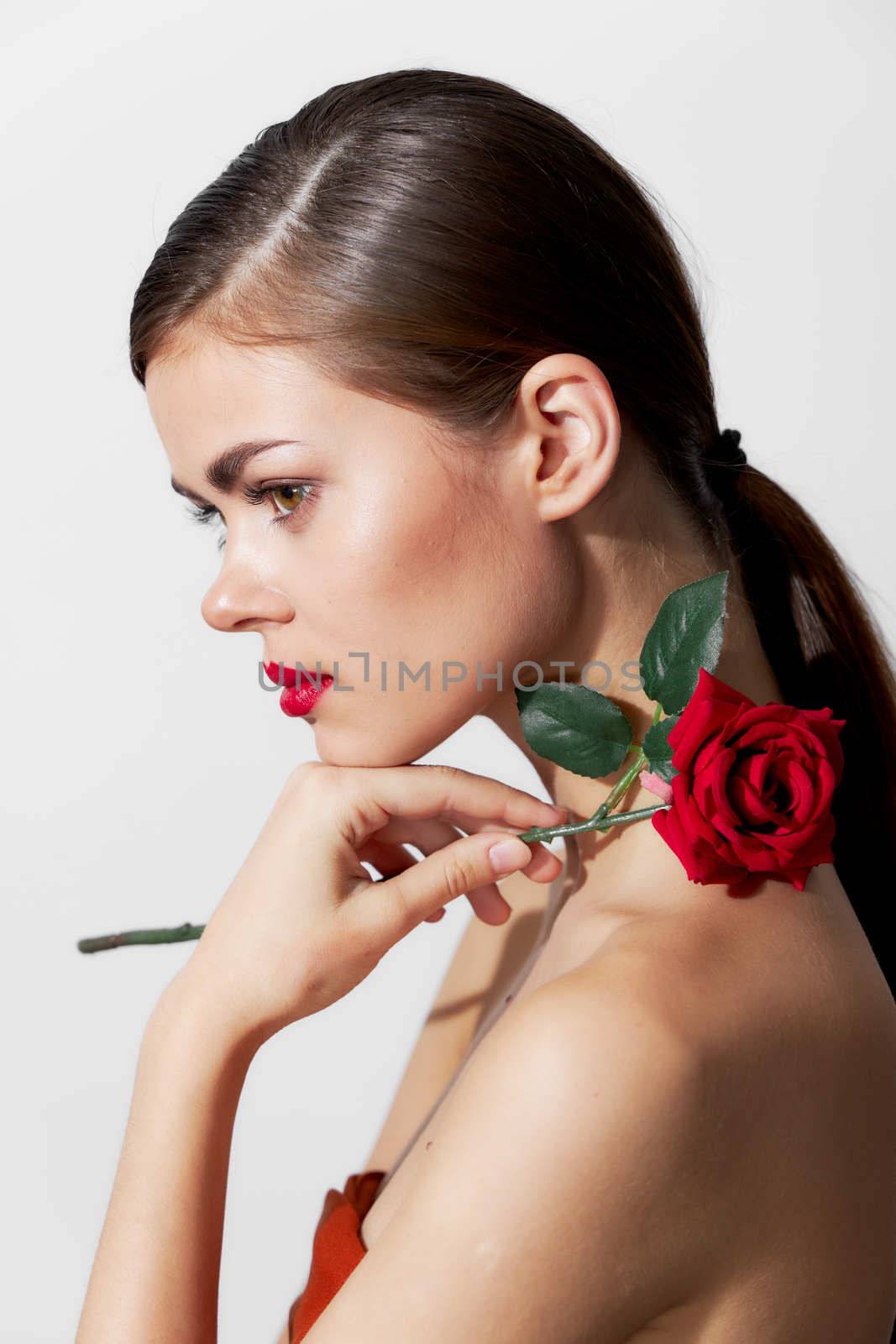 Woman with flower Red lips side view glamor bright makeup cropped view