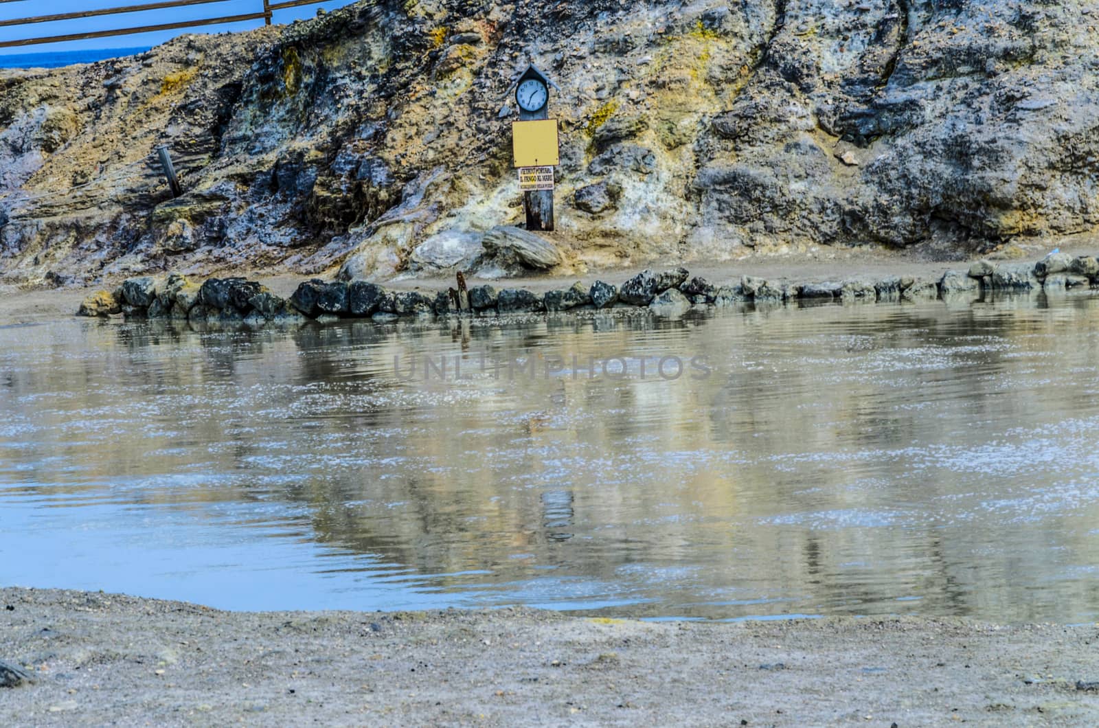 Natural swimming pool for mud baths with mineral components in the Aeolian Islands in this case Vulcano on the poster says PROHIBITED TO TAKE THE CLAY TO THE SEA Rinse in the puddle