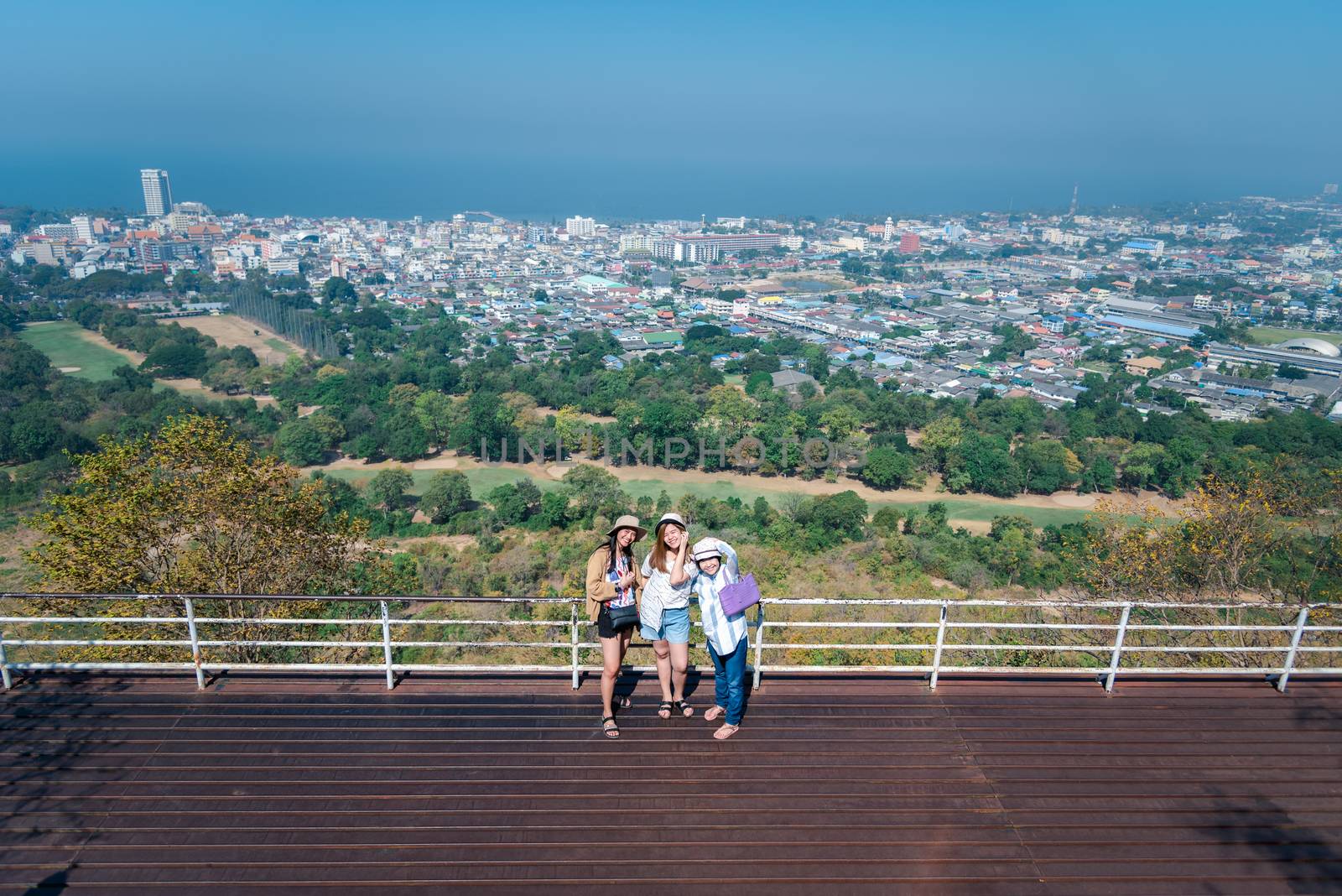 Asian pretty cute women with hat relax at seaside city landscape viewpoint on mountain with happy and freedom emotion in concept travel, vacation, leisure in life