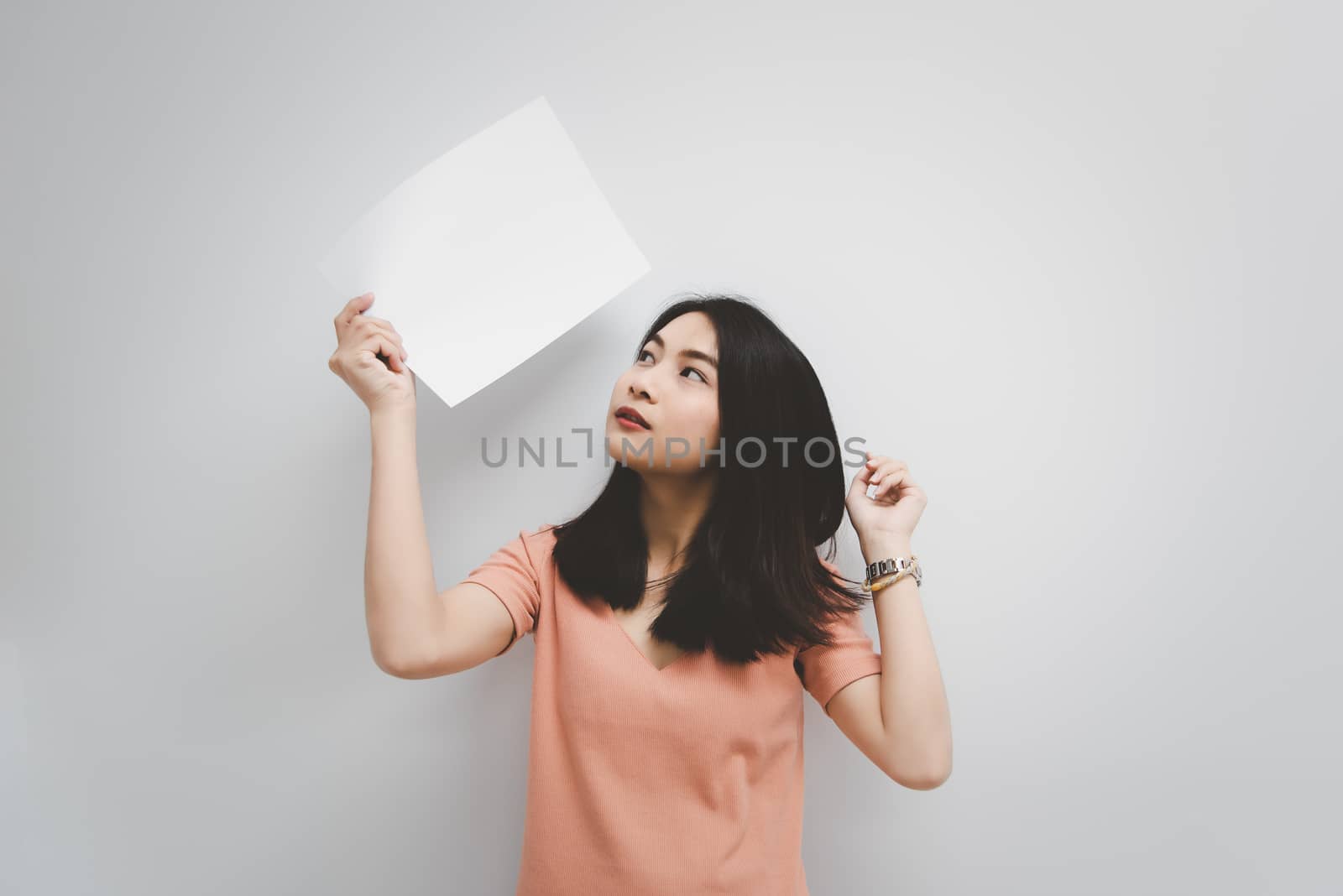 Asian pretty woman showing blank white paper for copy space and message with happy and smile in concept business woman and advertising