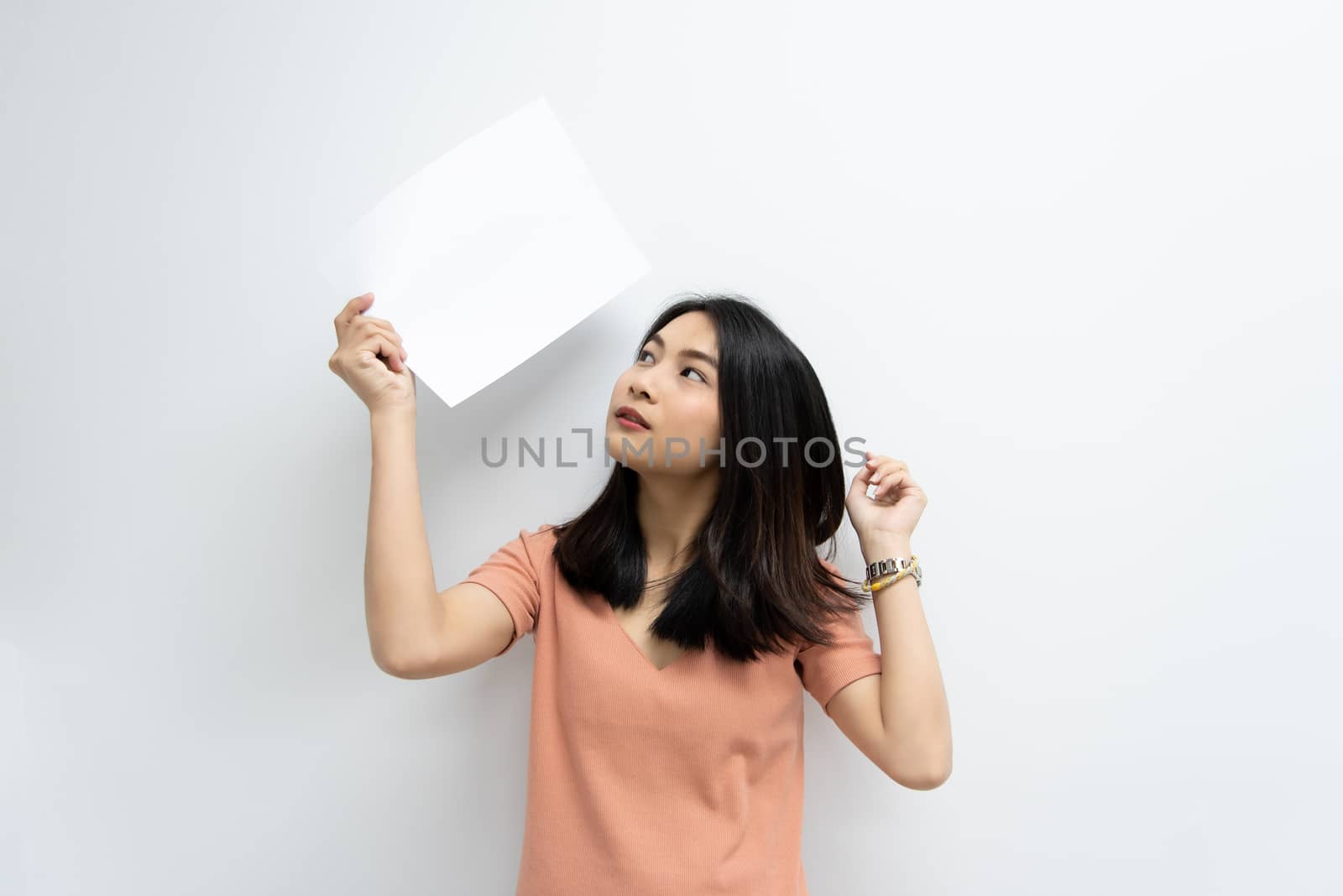 Woman showing blank white paper for copy space by PongMoji