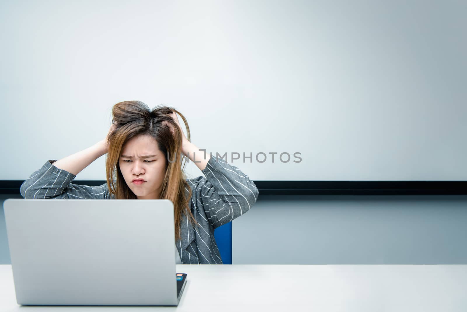 Woman working by laptop in office with annoyed by PongMoji