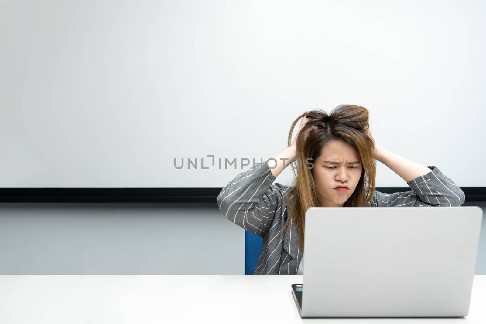 Woman working by laptop in office with annoyed by PongMoji