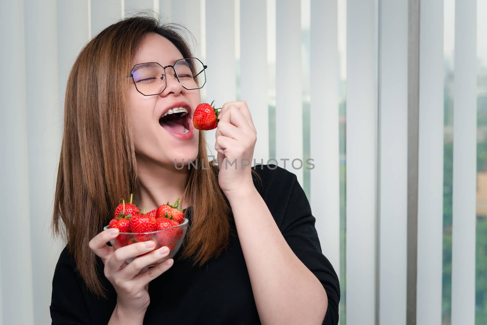 Woman eat strawberry red berry fruit sweet juicy by PongMoji