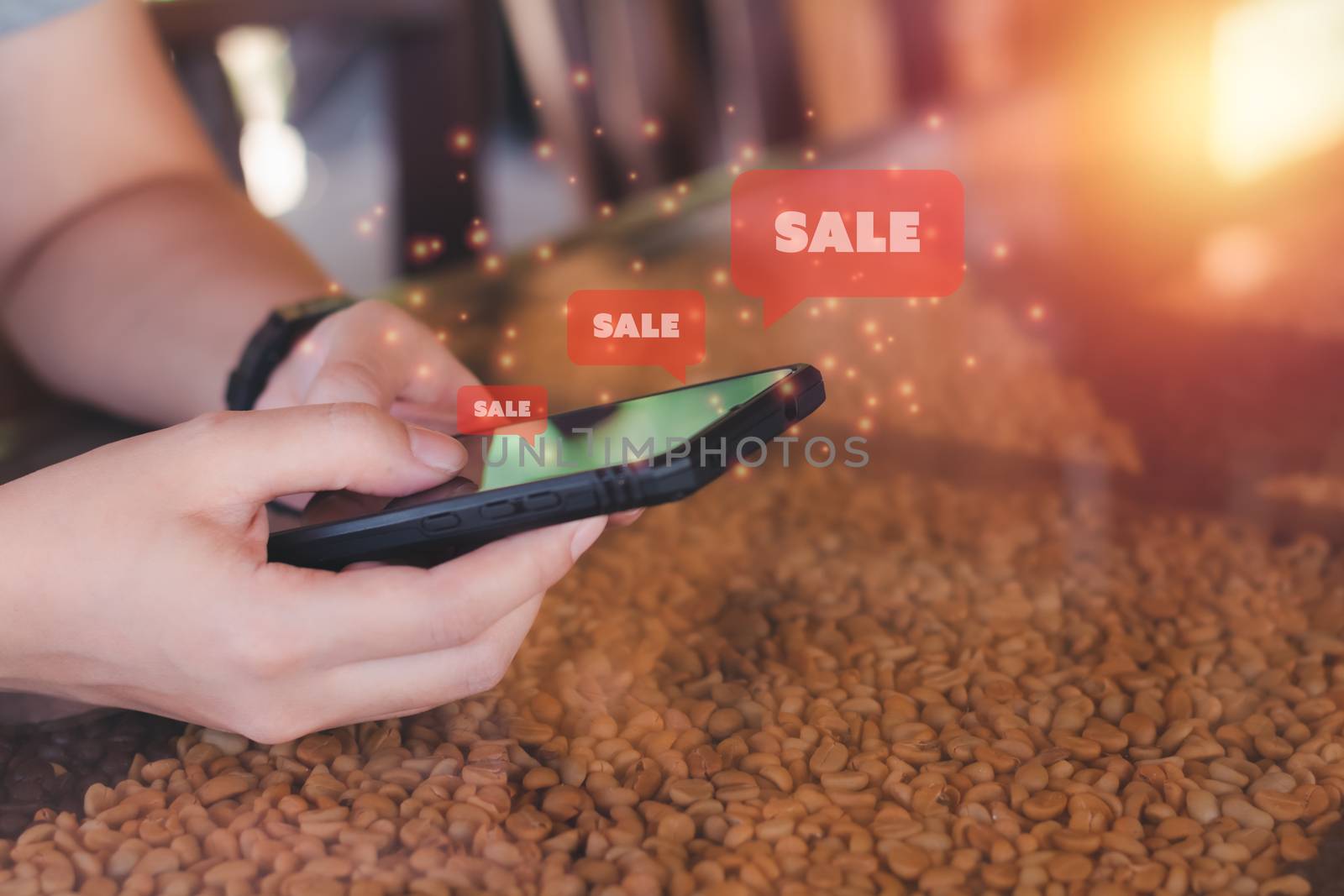 Shopping online concept. Hand holding black smartphone with red popup sale. Black Friday and shop at home.