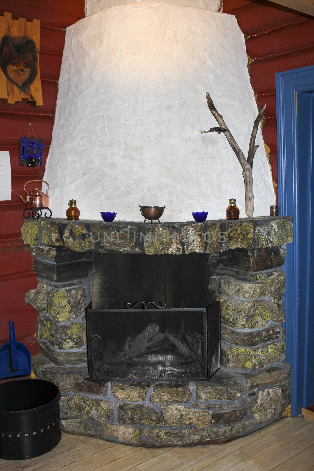 Old stone and wood fireplace in a Norwegian cabin in Hemsedal.