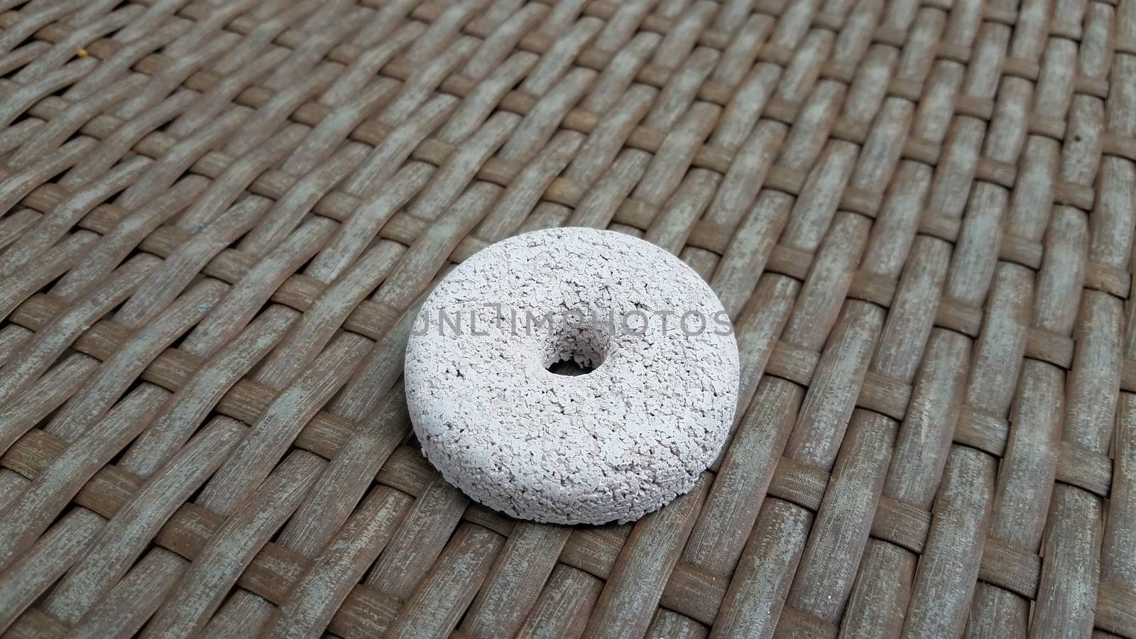 circular white mosquito tablet insecticide on brown surface or table