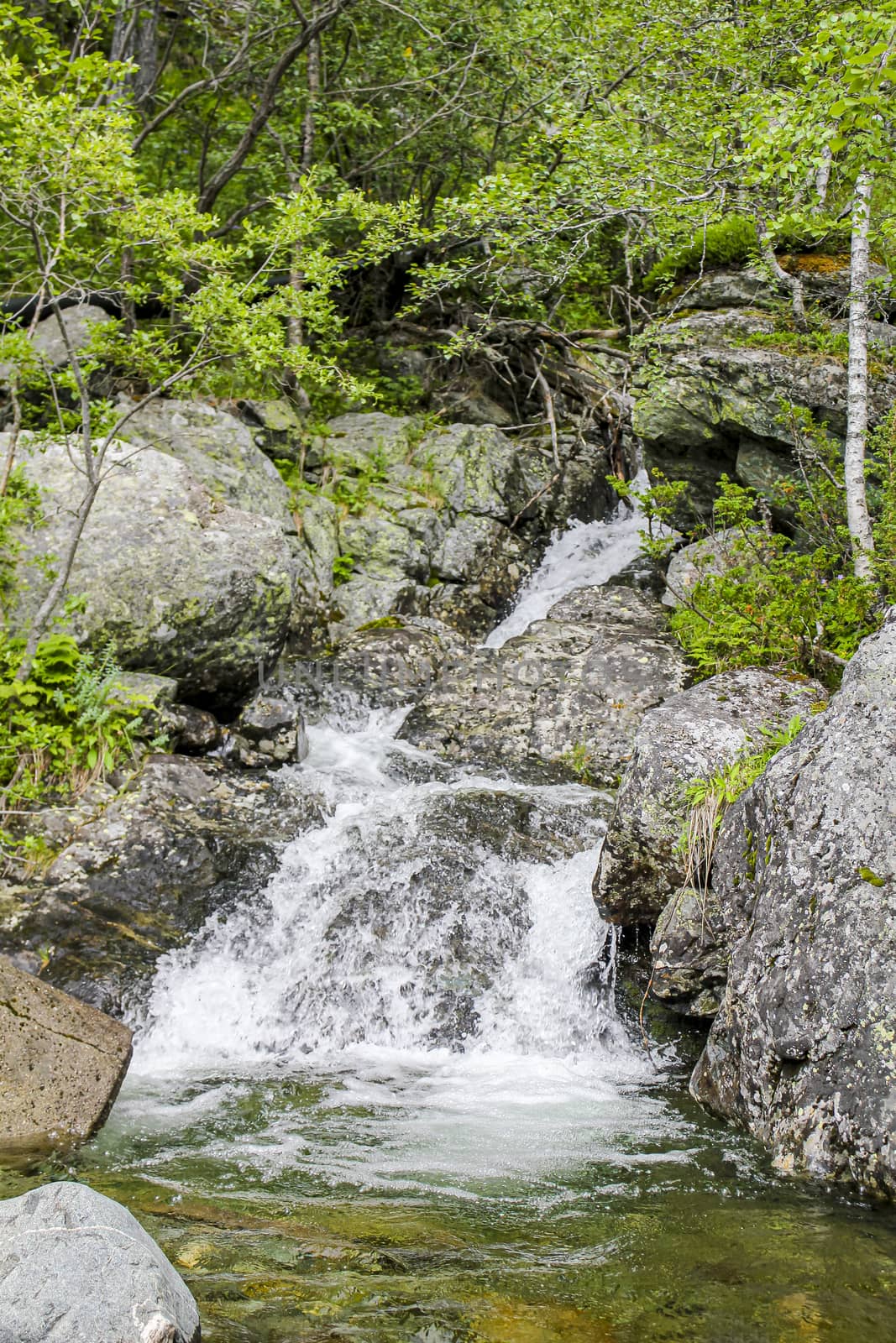 Flowing waterfall river Lake Hemsila in Hemsedal, Viken, Buskerud, Norway.