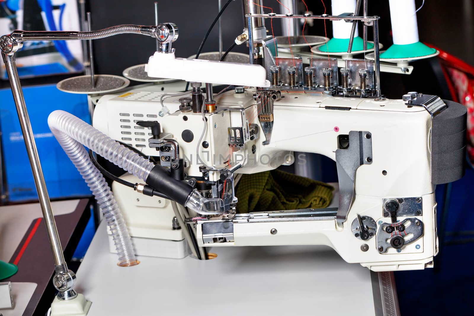 Professional overlock knitting and sewing machine, sewing equipment, close-up. by Sergii