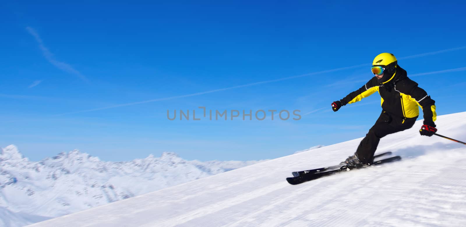 Professional alpine skier skiing downhill in high mountains of Alps banner background with copy space for text