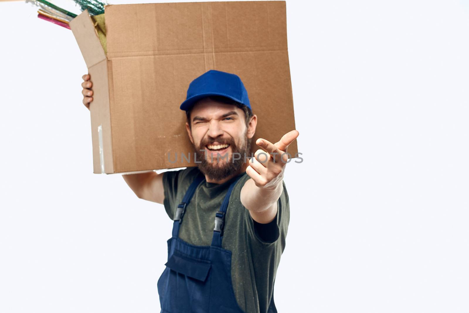 A man in a working uniform with a box in his hands delivery transportation work. High quality photo