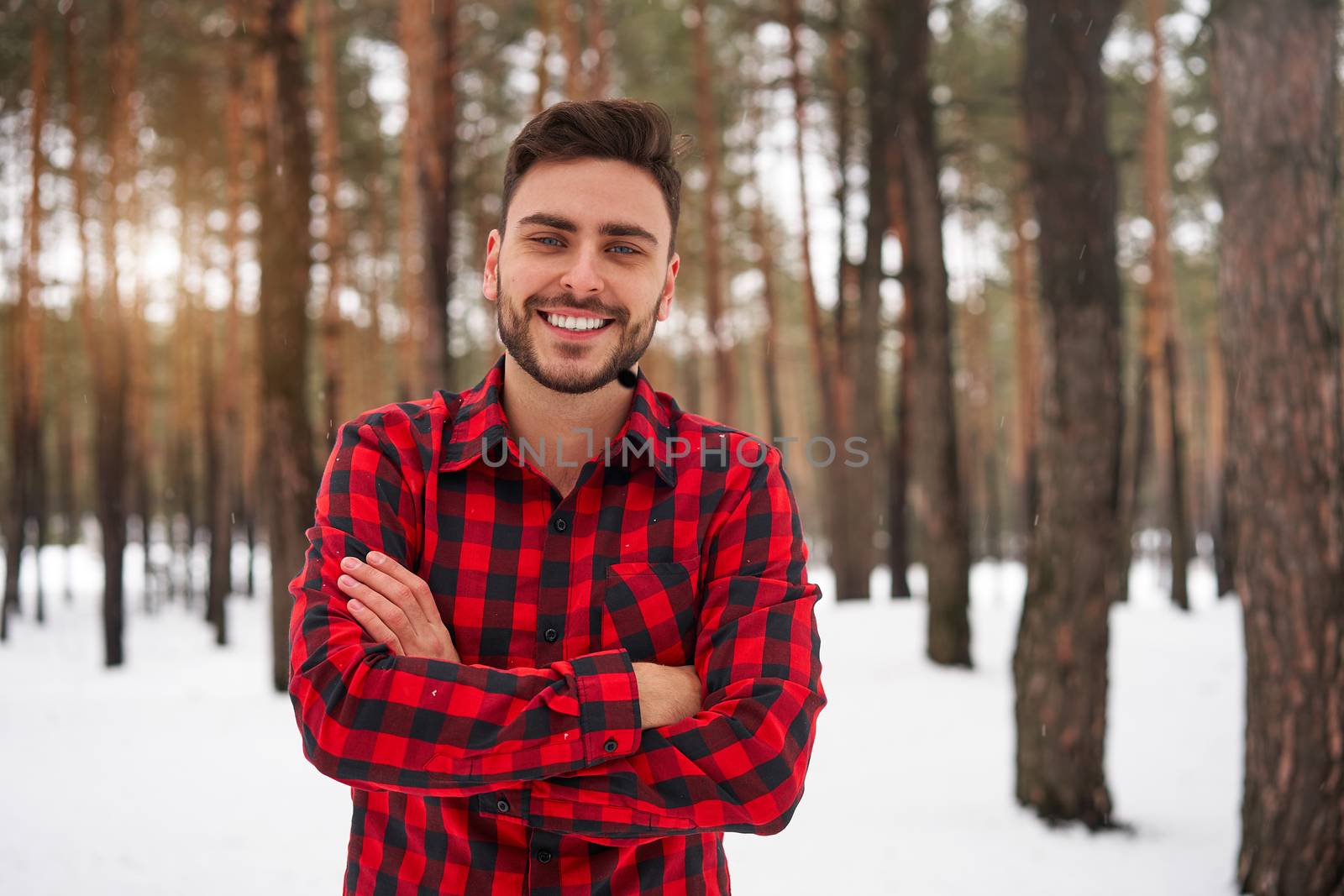 Handsome bearded young caucasian man red checkered shirt standing outdoors winter season forest Attractive stylish european gut walking snowy christmas woodland holiday leisure