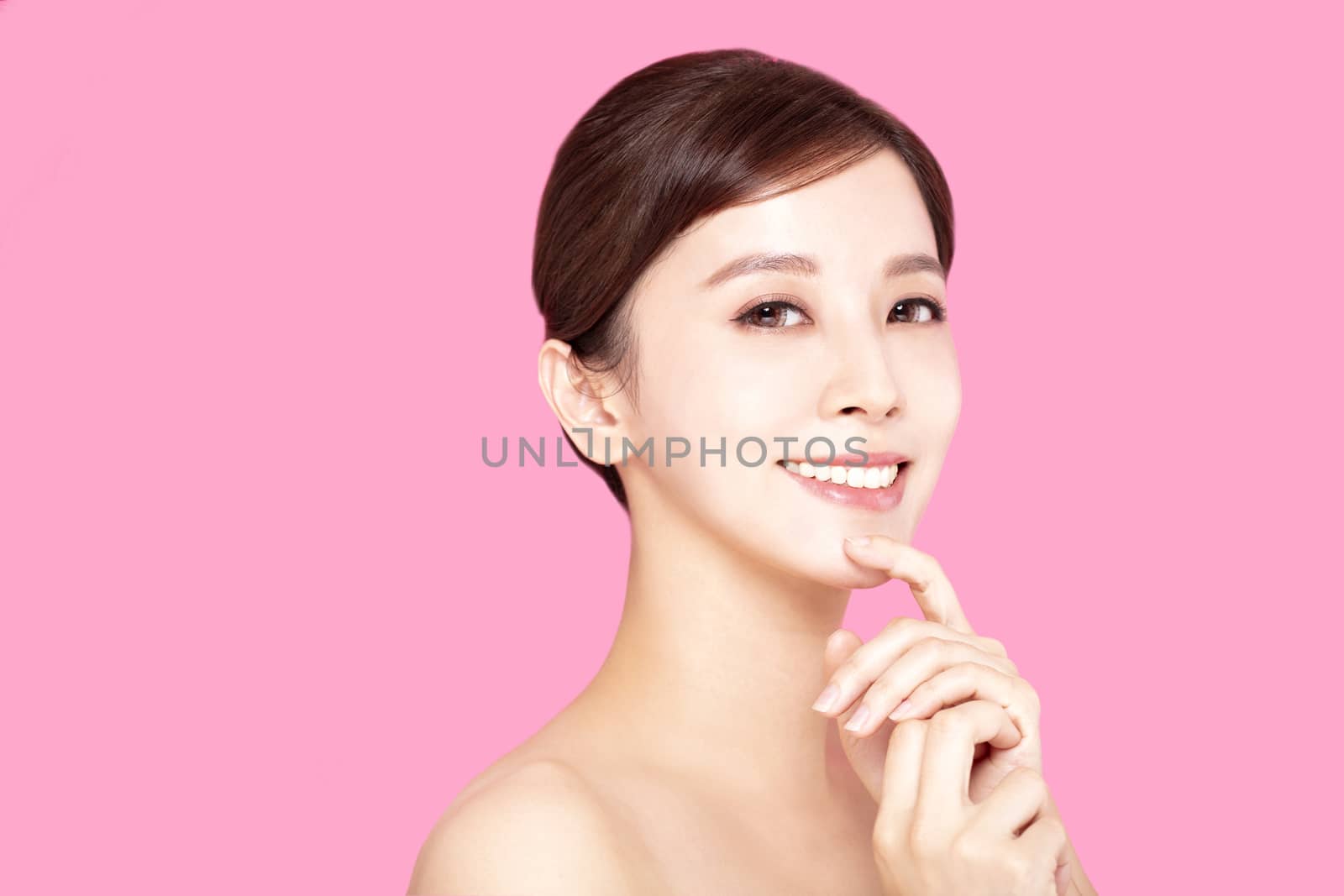 Close up of beautiful young woman's face with clean perfect skin by tomwang