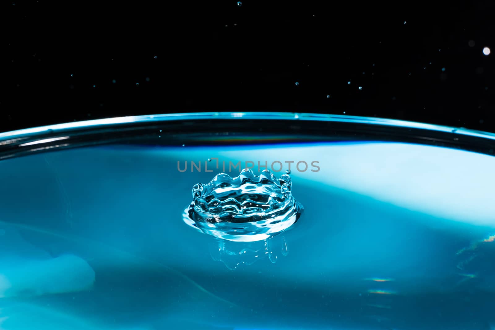 Abstract an outbreak of crown water.Splash of water close up.Frozen water drop photographed at high speed.Slow dripping of liquid with air bubbles.Nature backgrounds or Wallpaper.Frozen liquid splash