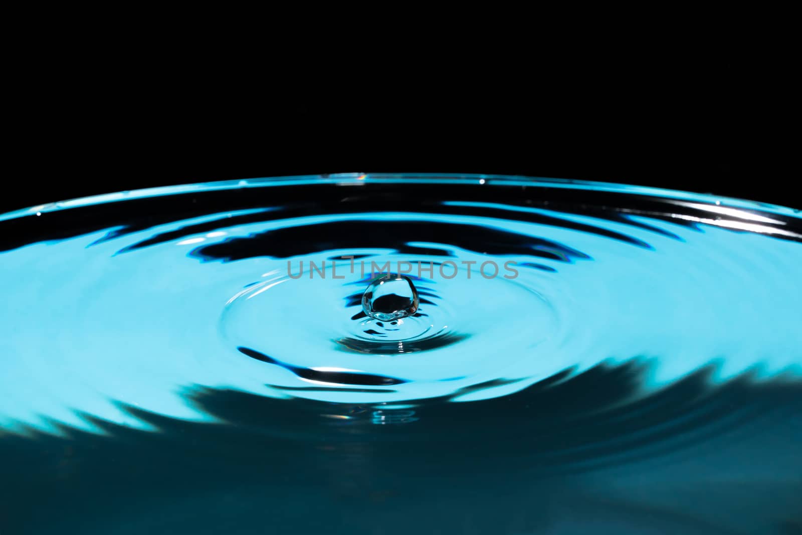 Abstract an outbreak of crown water.Splash of water close up.Frozen water drop photographed at high speed.Slow dripping of liquid with air bubbles.Nature backgrounds or Wallpaper.Frozen liquid splash