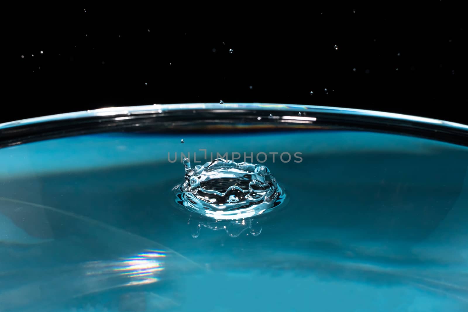 Abstract an outbreak of crown water.Splash of water close up.Frozen water drop photographed at high speed.Slow dripping of liquid with air bubbles.Nature backgrounds or Wallpaper.Frozen liquid splash