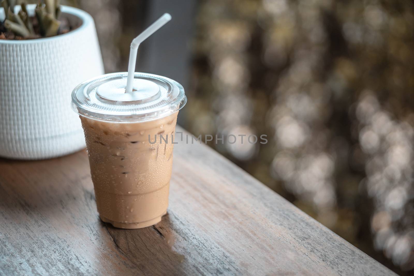 Close up glass of ice americano coffee on wood table, selective  by pt.pongsak@gmail.com