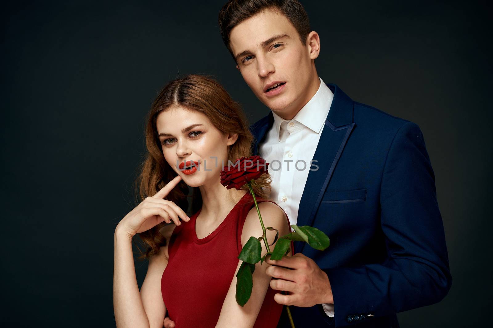 luxury couple hug romance relationship rose over dark isolated background. High quality photo