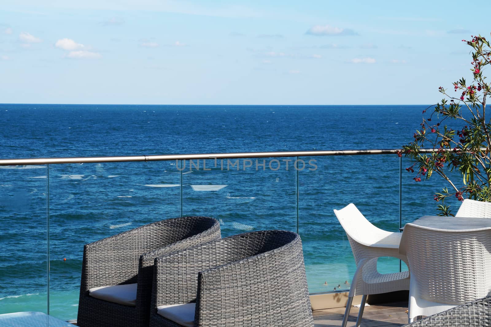 armchairs and a table for relaxing on the patio overlooking the sea by Annado