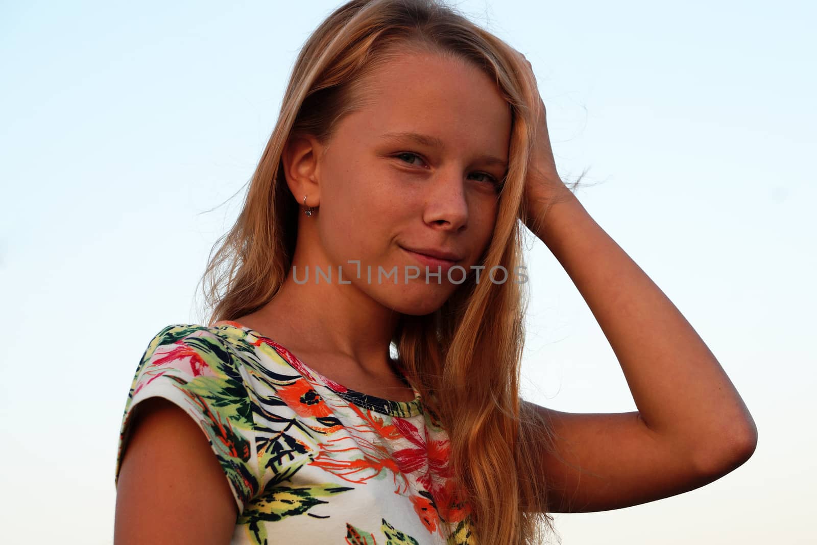 smiling girl with long blond hair, portrait on the white background