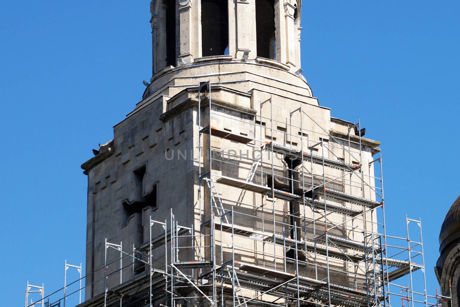 orthodox cathedral in scaffolding on a background of blue sky by Annado