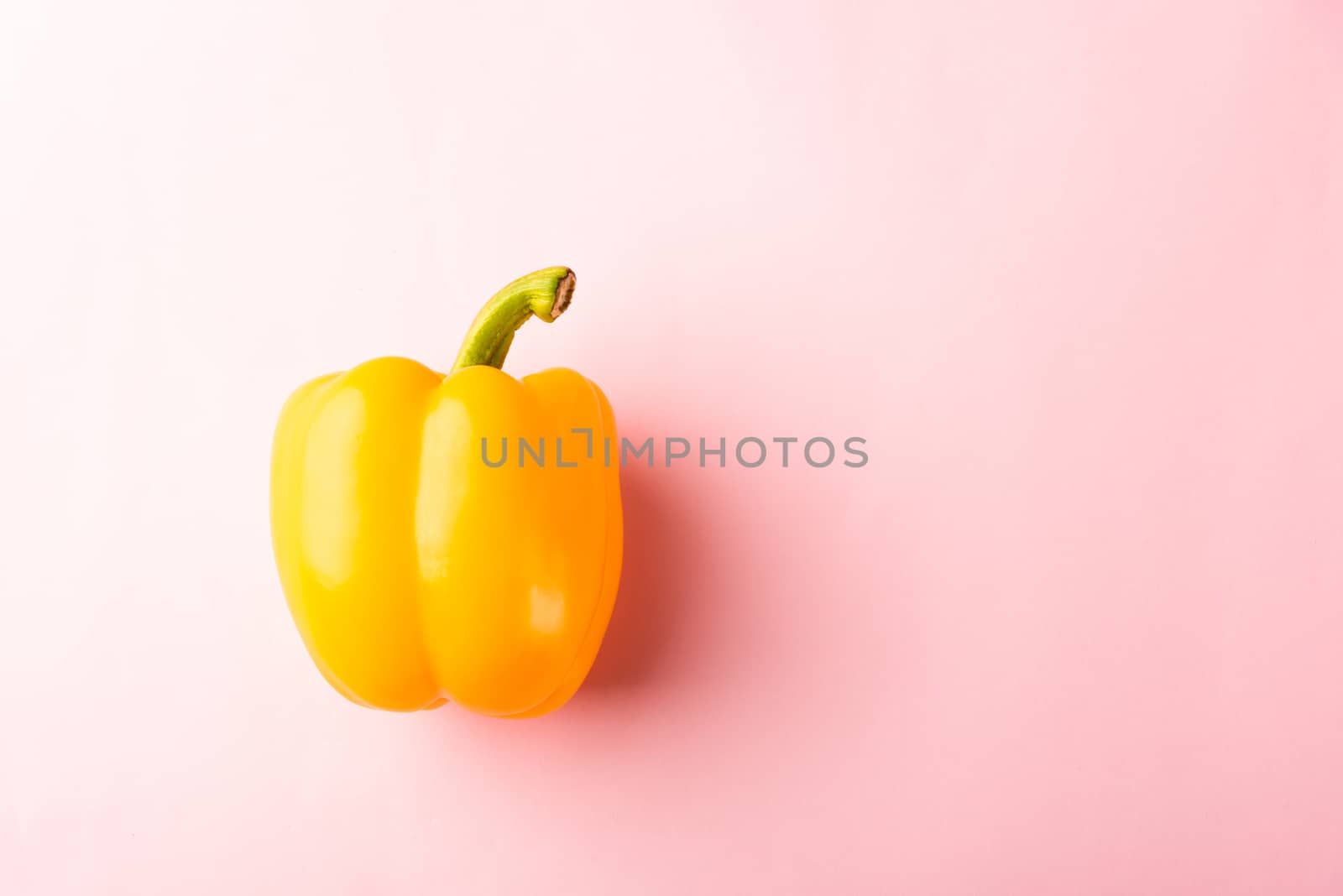Close up above top view of raw yellow bell peppers on pink pastel background, fresh organic vegetables, Healthy lifestyle diet food concept