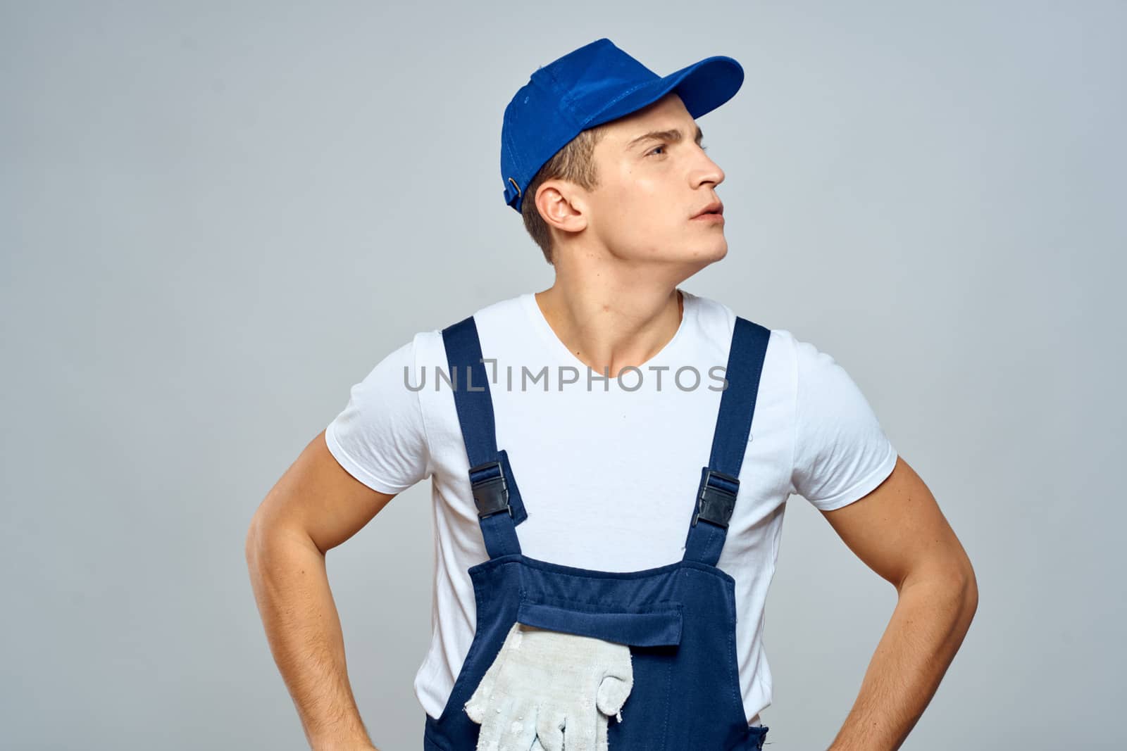 working man in uniform service lifestyle delivery service light background. High quality photo