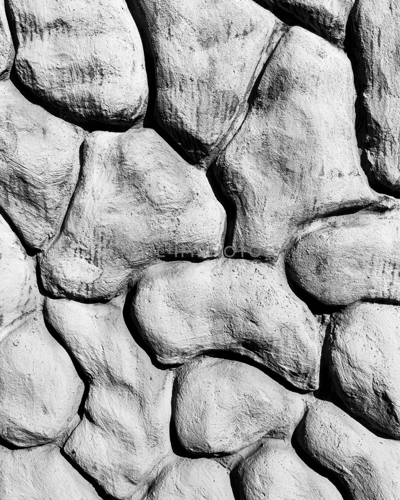 Black and white texture of a wall made of stones. Abstract background for design.