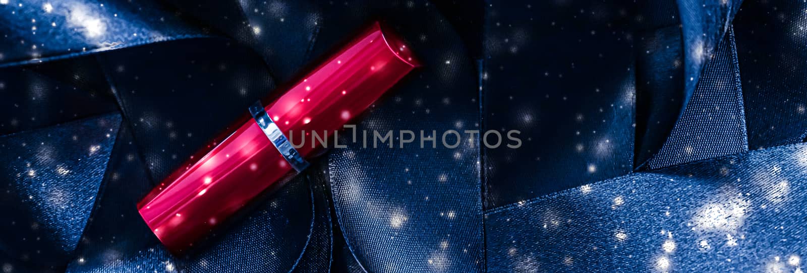 Red lipstick on blue silk and shiny glitter background, luxury make-up and beauty cosmetics