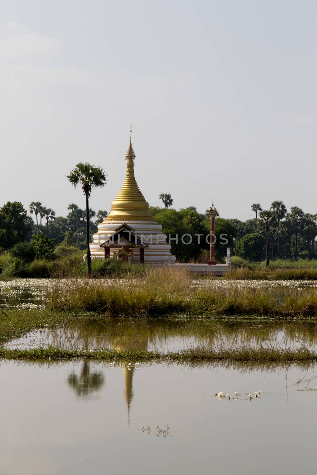 Inwa Island, Mandalay, Myanmar, stupa and temple in landscape reflected in water. Pagoda on Inwa island at Ayeyarwady River near Amarapura, Myanmar, Burma High quality photo