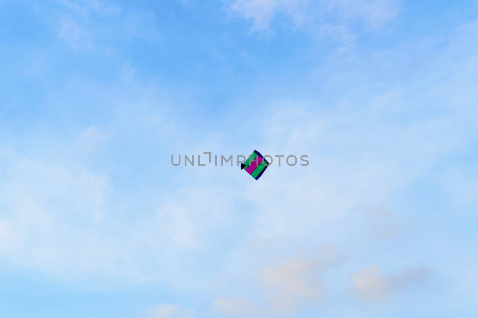 Kite flying in the sky. Kites flying picture with blue sky and white clouds. Photography in the eve of Vishwakarma Puja in Kolkata. Low angel View. Motion Blur. by sudiptabhowmick