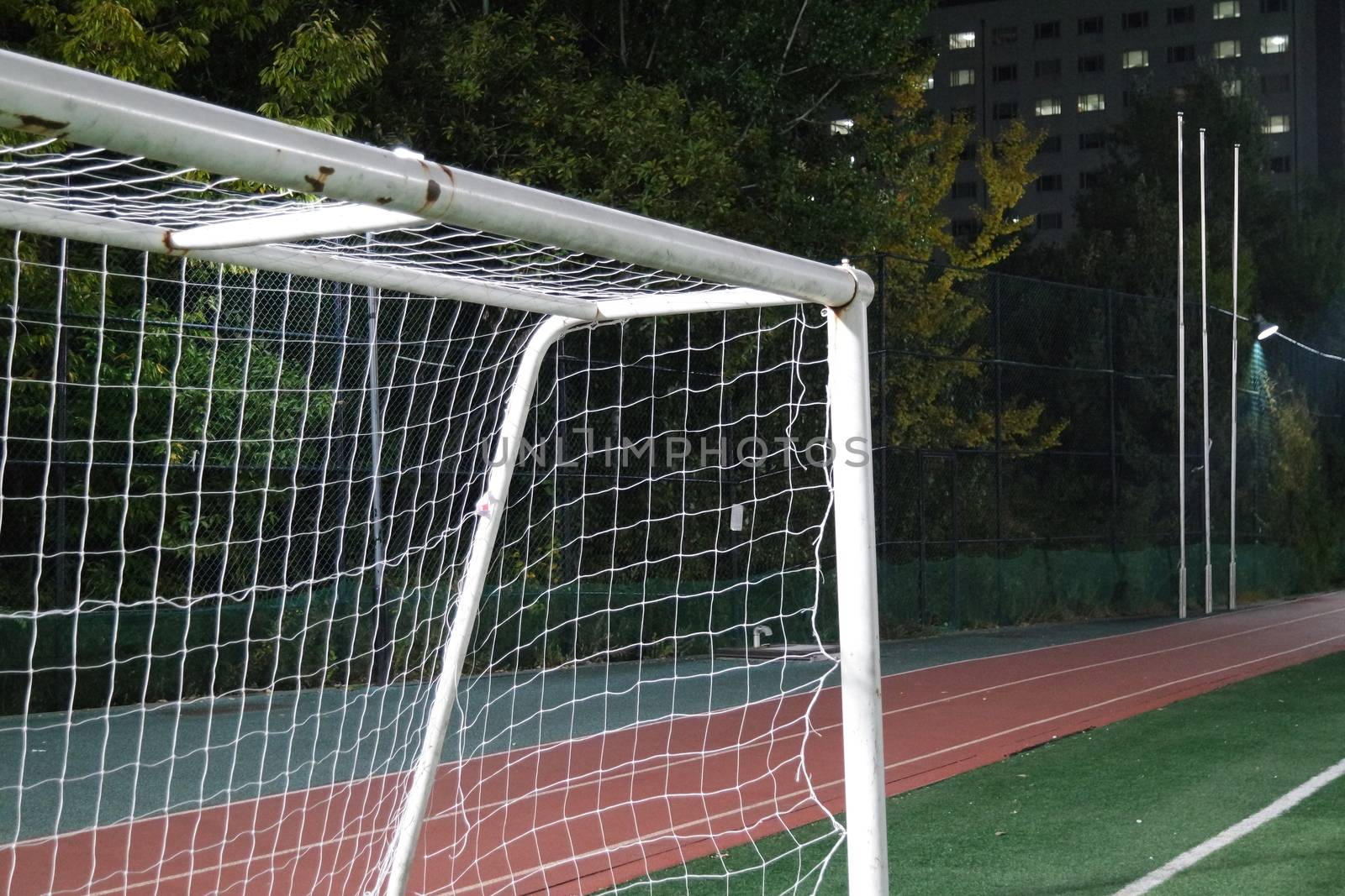 Closeup view of goal net in a soccer playground by Photochowk