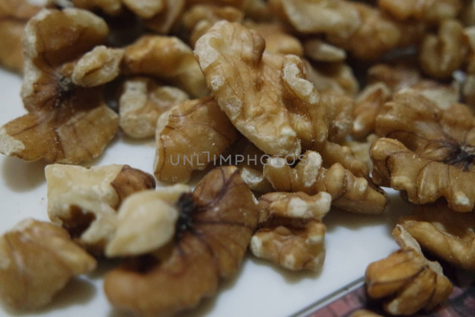Close-up top view of peeled walnut on a white background. peeled walnut without shell ready to eat dry fruit.