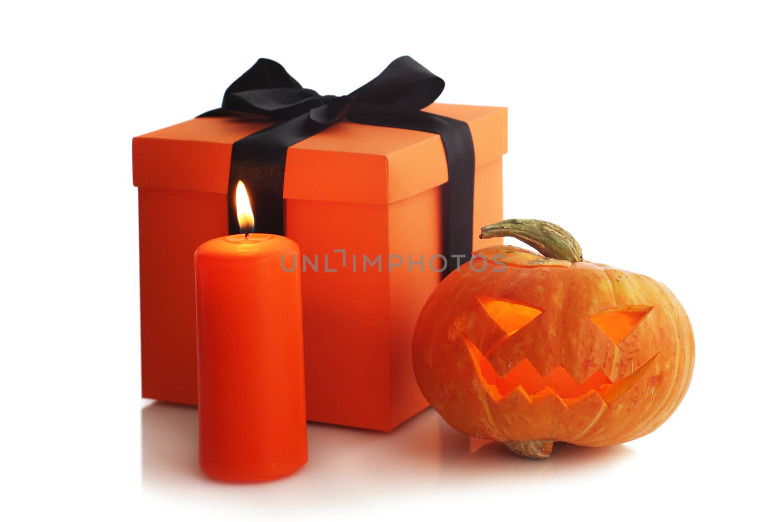 Halloween pumpkin candle and gift isolated on white background