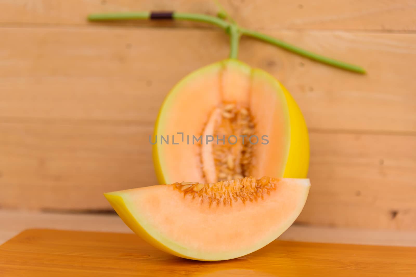 fresh golden melon on wood plate by rukawajung