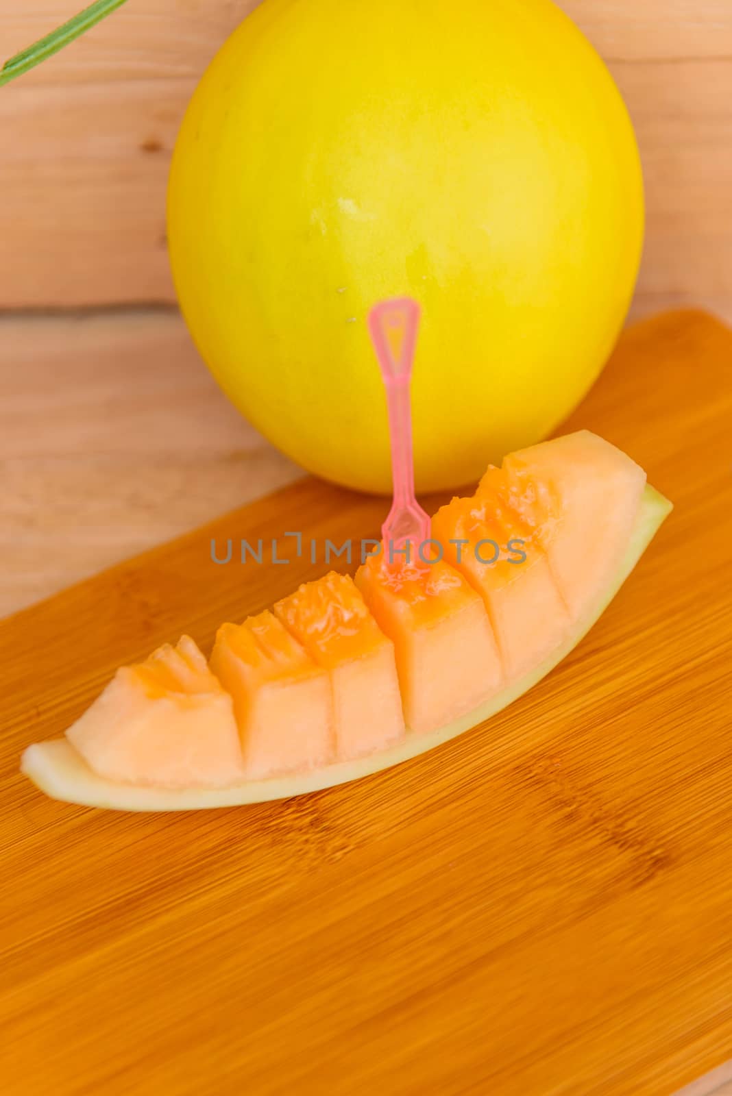 fresh golden melon on wood plate by rukawajung