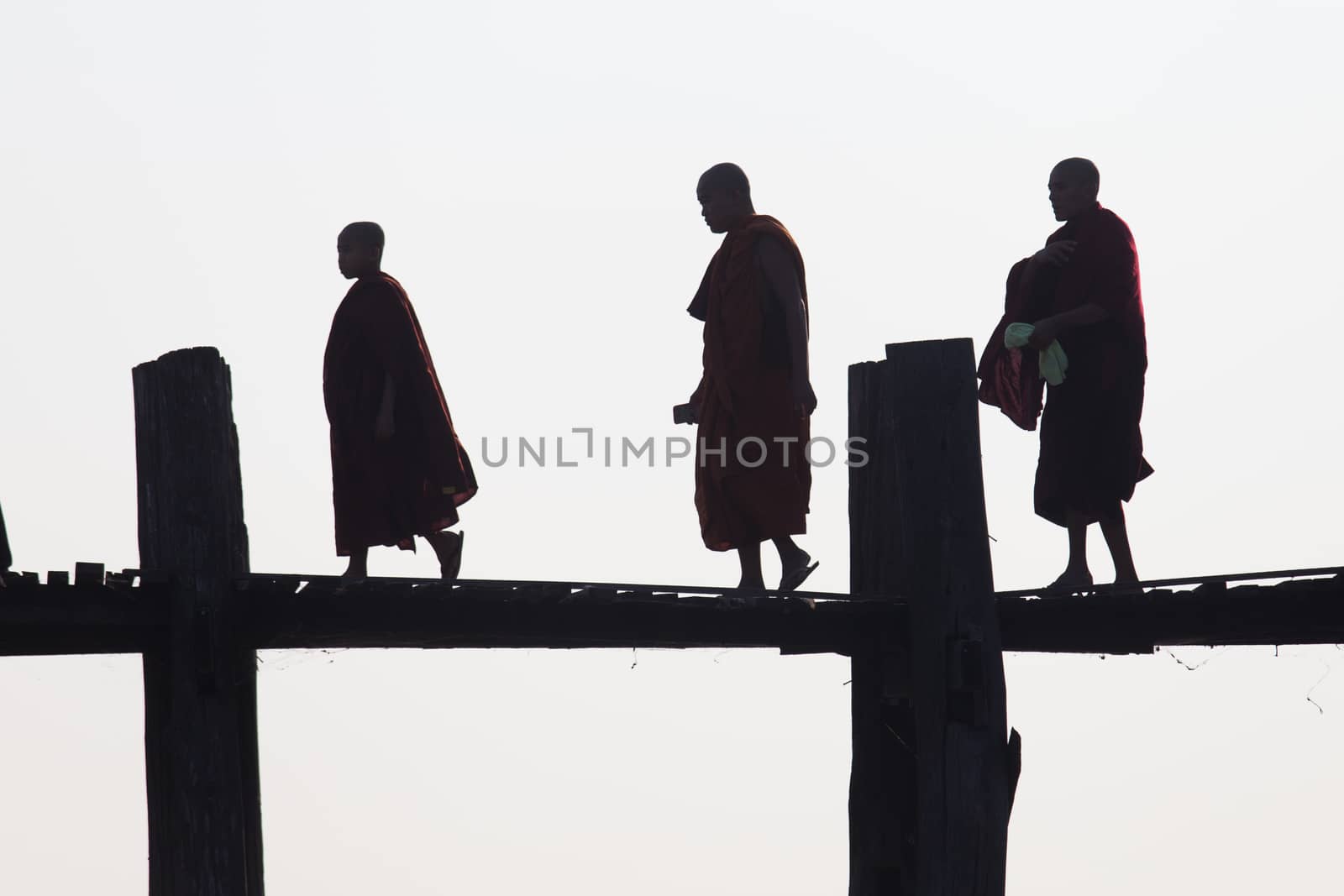 Silhouettes of local people walking on u bien bridge Mandalay, Myanmar. High quality photo