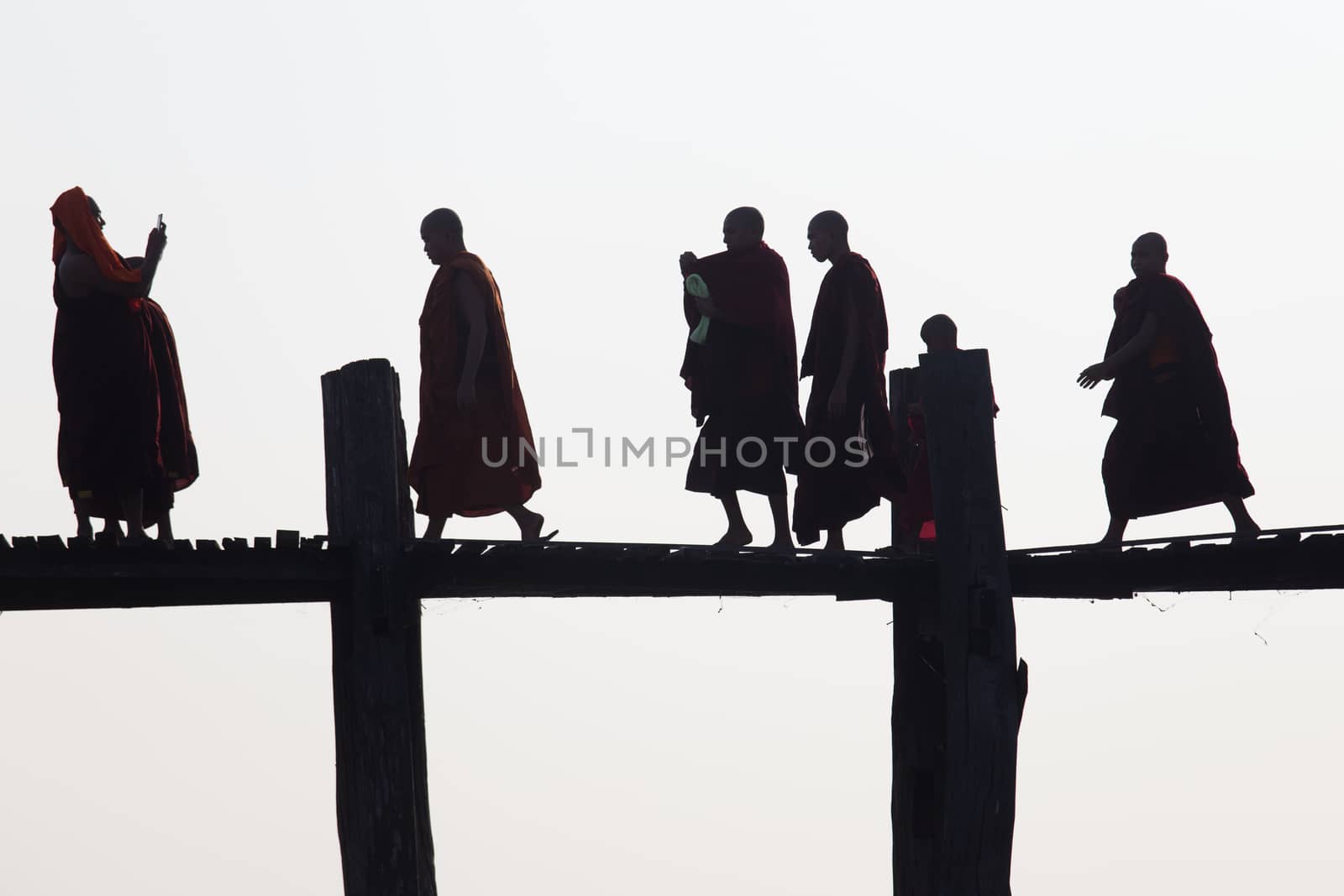 Silhouettes of local people walking on u bien bridge Mandalay, Myanmar by kgboxford