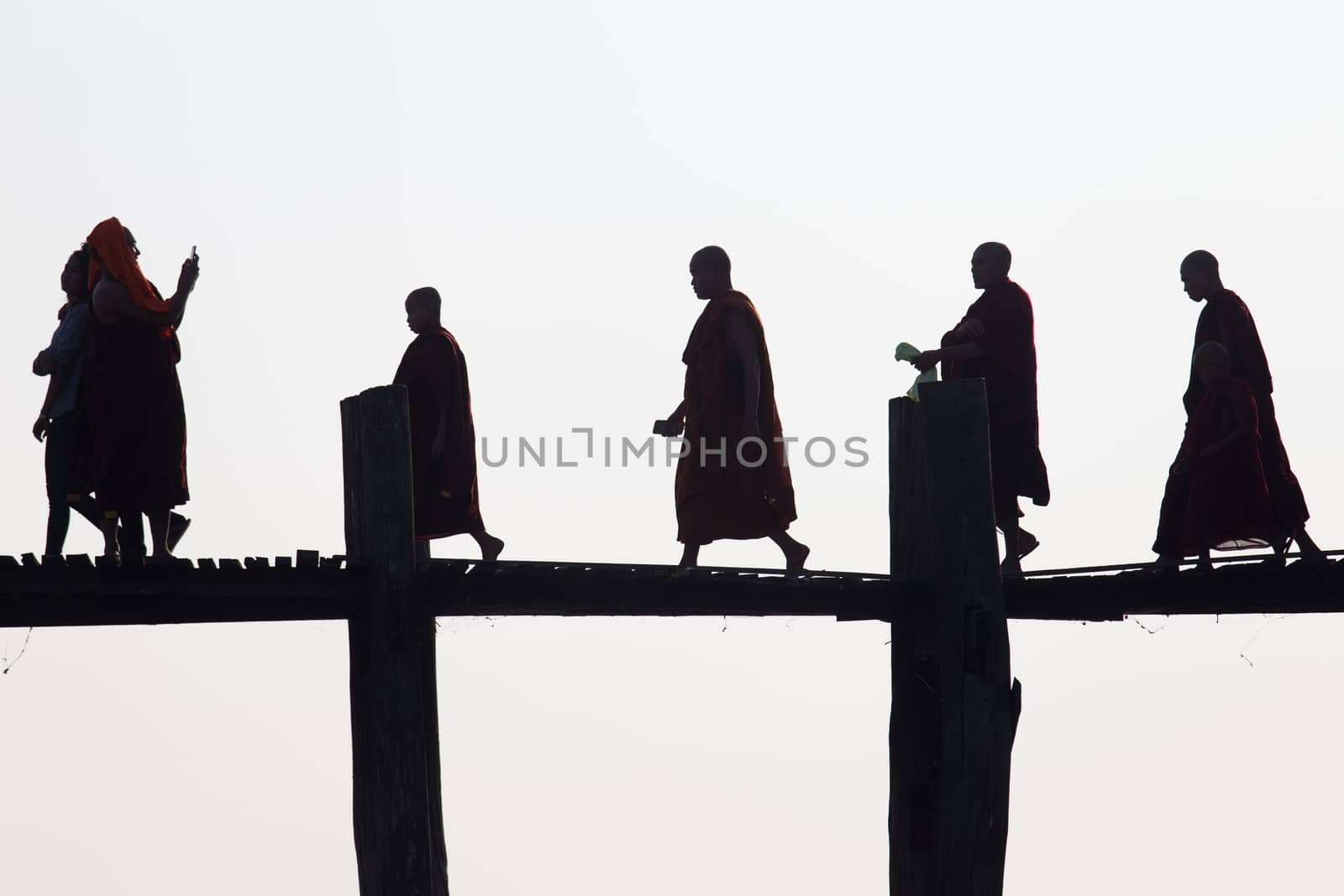 Silhouettes of local people walking on u bien bridge Mandalay, Myanmar. High quality photo