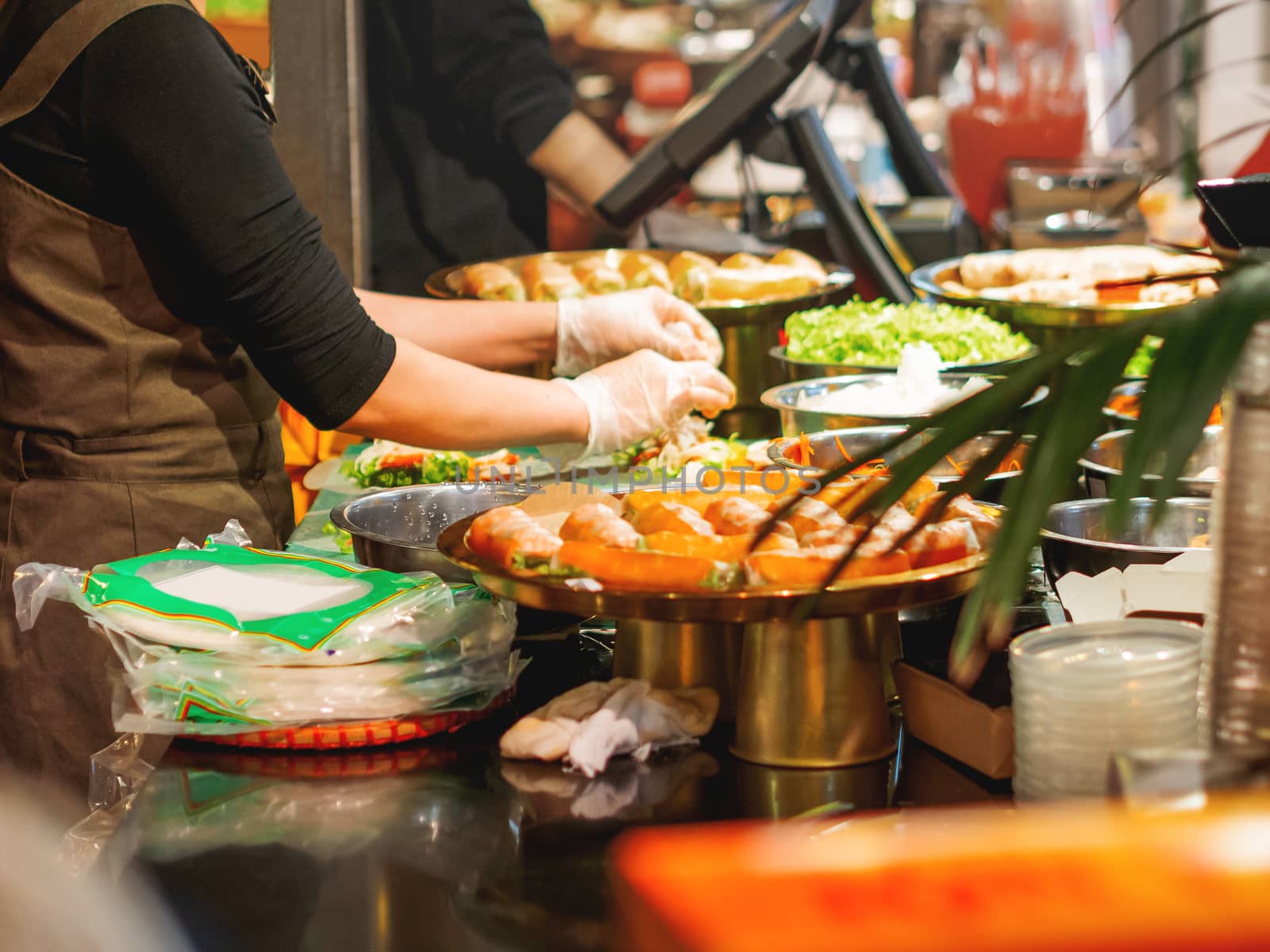 Chef cooks something tasty in Vietnamese restaurant. Dishes with prawns for Asian cuisine. Restaurant kitchen.