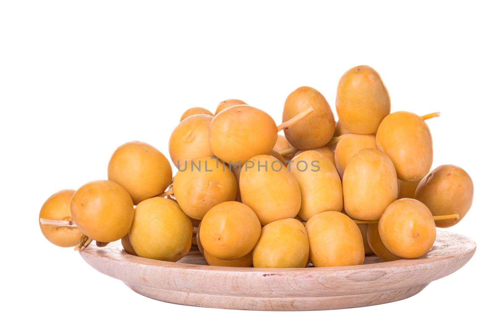 Dates or date palm in wood bowl isolated on white background.