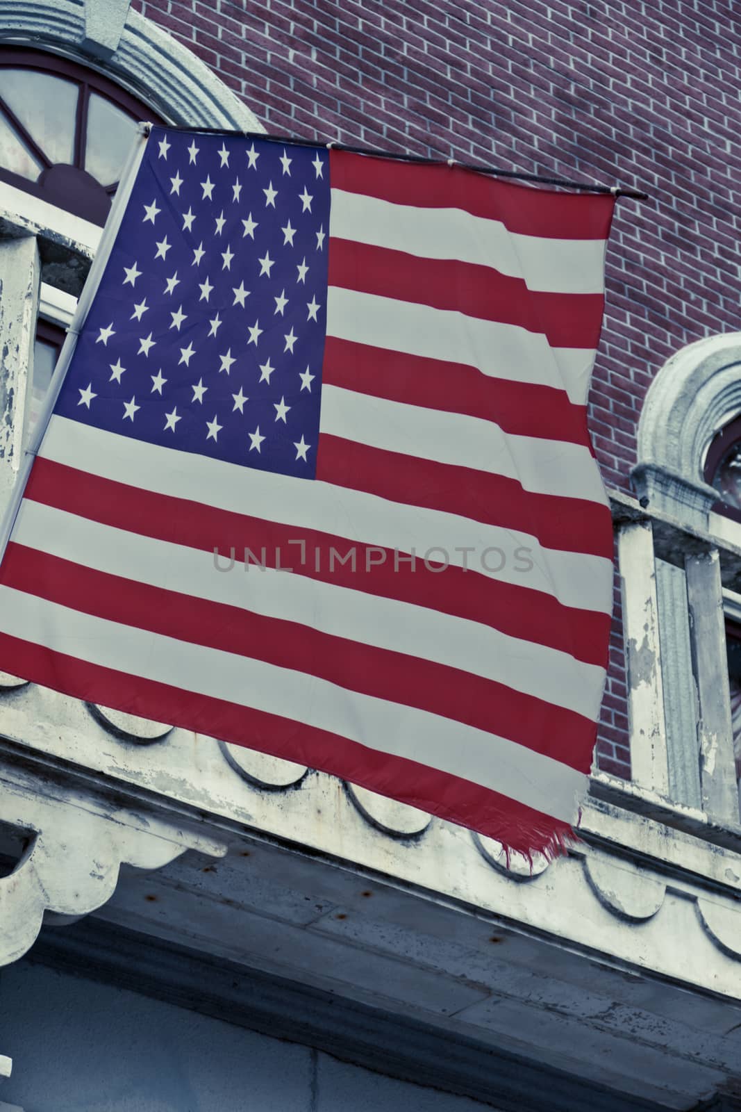 American flag in front of old style building by imagesbykenny
